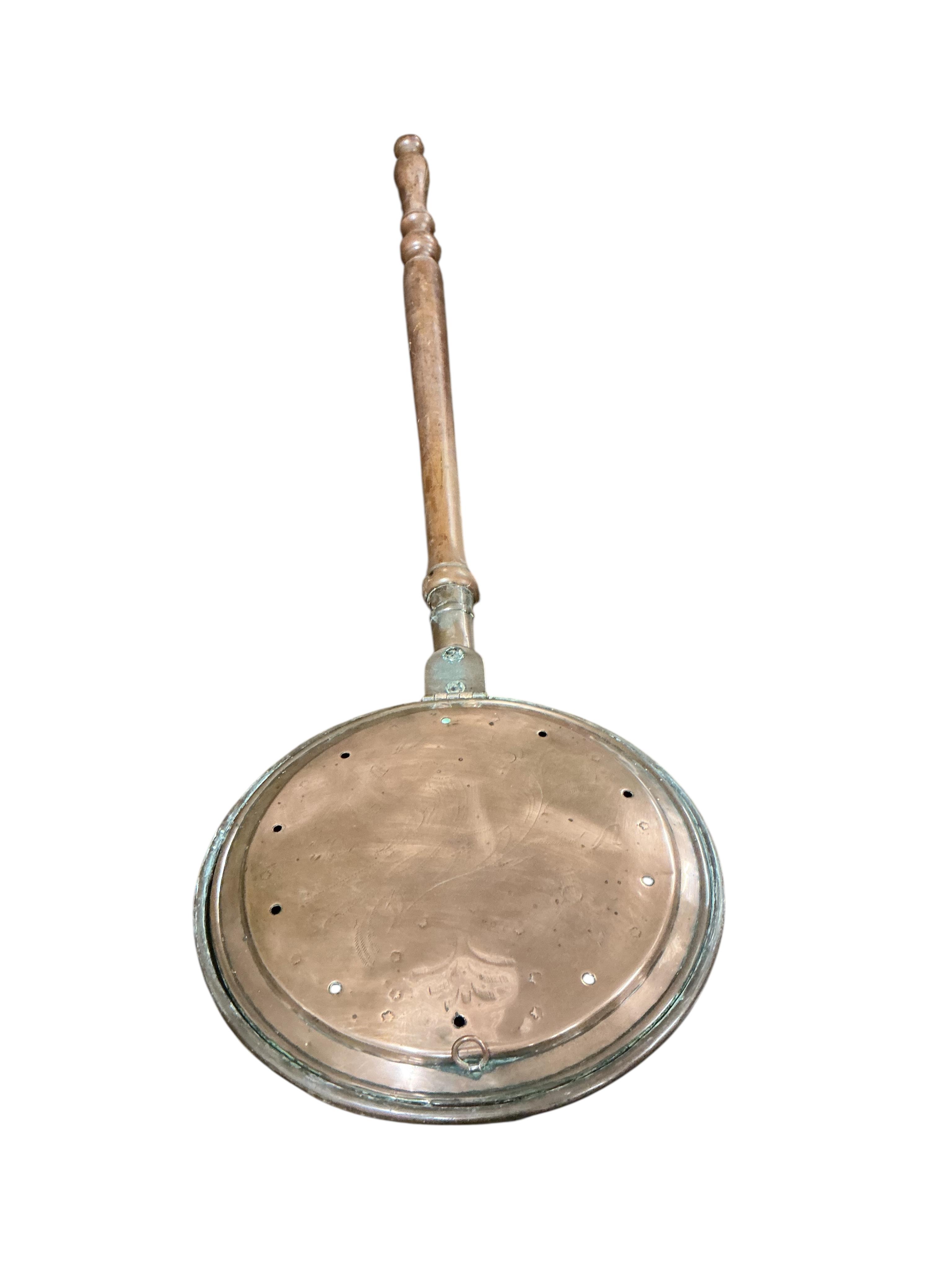 A 19th century copper mounted iron kerb, a set of carved oak bellows together with a collection of Victorian and later copper and brass ware